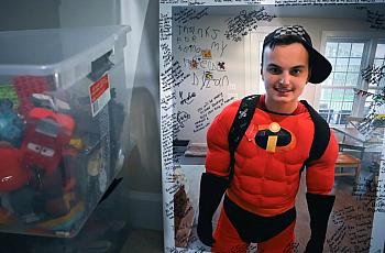 An image of Zachary Chafos, dressed as Mr. Incredible, at his Maryland home