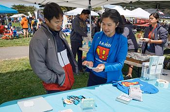 Two people at health camp interacting with one another