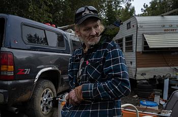 A person with a bird on their shoulder