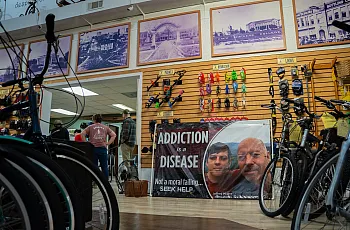 A sign reads “Addiction is a Disease”