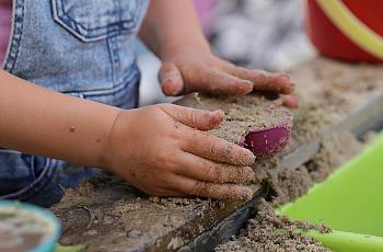 Child playing with sand.