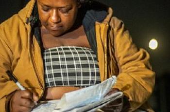 Person writing in a book