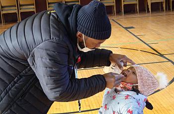 A parent helps his three-year-old daughter with a COVID test in Chicago in late 2020.