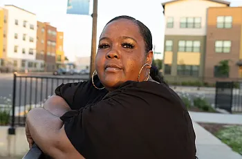 Person in black top standing on a railing