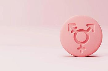 Pink pill with gender symbols on it