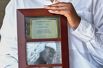 Hands holding framed photo
