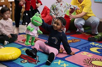 A child playing with a soft toy