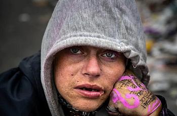 An image of a homeless person looking in the camera