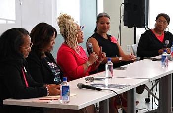 People at a table, with a person talking on a mic