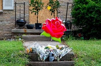 Balloons and flowers outside a home