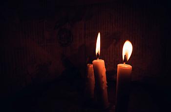 Two Candles Lit Inside a Dark Room