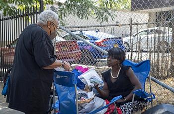 Person distributing hygiene supplies to another person