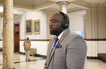 A person in suit with headphones