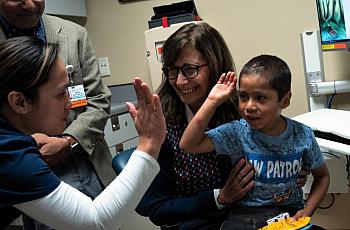 Six-year-old Abraham Gonzalez-Martinez celebrated a successful checkup at UCLA in November 2019 aloCortez, lefng with Dr. Manish Butte, back left, nurse Jackylout, and Dr. Maria Garcia-Lloret. (Credit: UCLA)