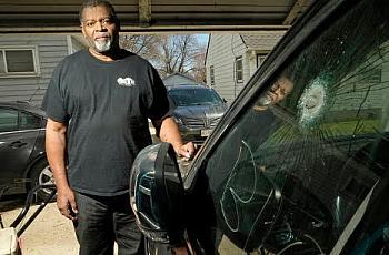 Pastor Kevin Simmons, who was shot during a carjacking, stands next to the Jeep he was in when he was shot