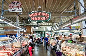 Large room with lit up market sign
