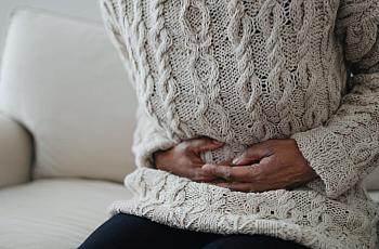 A person holding their stomach as if in pain