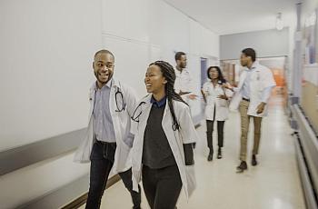 People in white coats walking