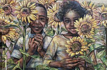 Wall mural of 2 children surrounded by sunflowers