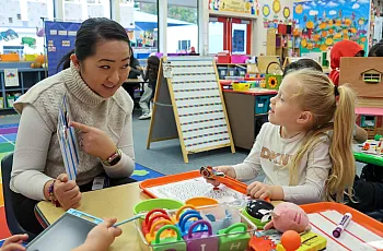 A child and her teacher