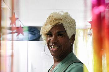 A person with golden hair and large earings