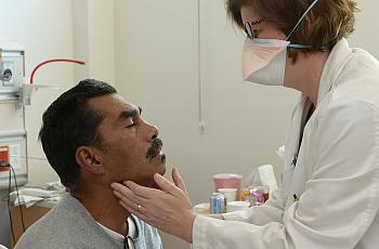Tuberculosis patient Joe Ordaz is examined by Dr. Caitlin Reed