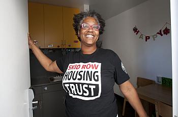 Evelyn Hilliard, formerly homeless on skid row, greets visitors at her studio in Star Apartments.