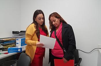  Medical assistant Deisy Hernandez discusses an upcoming appointment with patient Caya Mendoza, 62, inside Clinica Romero in Boy