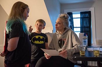 Tiana Warriner looks at a comic strip her daughter, Sophia, 9, drew, featuring their two new kittens as action heroes as her son