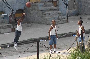 Kids playing basketball on a Baltimore street.