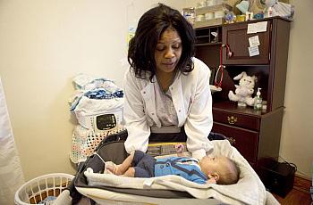 Flossie Horace takes oxygen levels and weighs her 3-month-old grandson every morning in her Roanoke home.