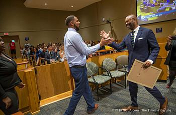 New Orleans Councilmember-at-Large Jason Rogers Williams, shakes hand of A. L. Davis Park Panthers head coach Shawn Scott