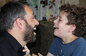 Michael Ashline, left, and his son Andrew, a special needs student in Orange, at their home in 2014.