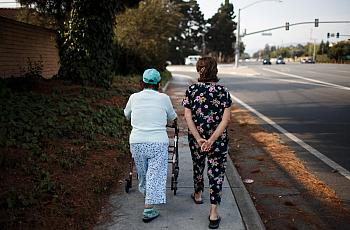 Ana Nicho Luu, 66, right, takes her mother, Maura Nicho, 90, who has Alzheimer’s disease, for a short walk around their Santa Cl