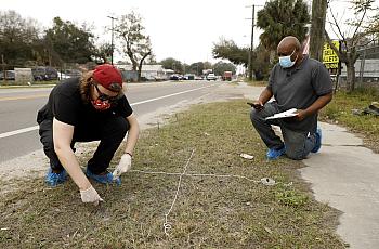 Tampa Bay Times reporters Eli Murray and Corey Johnson take soil samples near the Gopher Resource factory in January 2021 in Tam