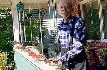 Gene Ampon, 75, photographed in August 2021 on the porch of the Seattle home he shared with his life partner for decades. Wind c