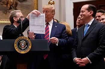 President Trump looks at a medical bill as he speaks during an event calling for legislation to end surprise medical billing at 