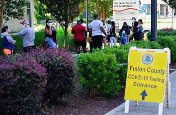 People stand in line to get tested for COVID-19 at a free walk-up testing site on July 11, 2020 in Atlanta, Georgia