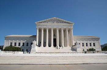 The Supreme Court building - a white building with roman columns. 
