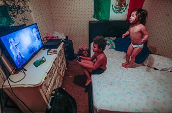 Romeo, 8, and his sister Victoria, 3, play in their mobile home. The family was among those profiled in the reporter’s series on