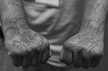 Tattoos — symbols of the struggle of his earlier years — warn you against crossing a former gang member. (Photo by Sahra Sulaiman/LA Streetsblog)