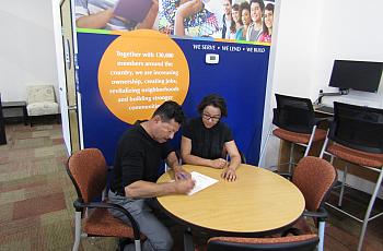 Jorge Castro, a member of the Self-Help Federal Credit Union in San Diego’s City Heights neighborhood, fills out an application 