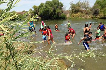 On a 105 degree day, kids play in the San Joaquin River as part of River Camp. Ezra David Romero Valley Public Radio