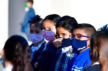 A student adjusts her facemask at St. Joseph Catholic School in La Puente, California in November 2020