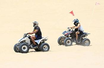Two riders on quads ride in the OHV area of Oceano Dunes in June. Laura Dickinson