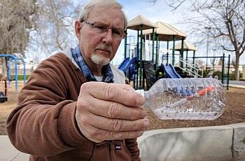 Oildale Community Action Team director Dave Kadel stands with a hypodermic needle he found.