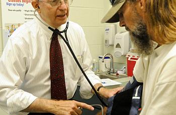 Dr. Michael Lewis, secretary of the state Department of Health and Human Resources, volunteers at the West Virginia Health Right