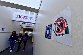 Students walk past one of the many anti-bullying signs posted around Harry S. Truman Middle School in Fontana on Thursday, March