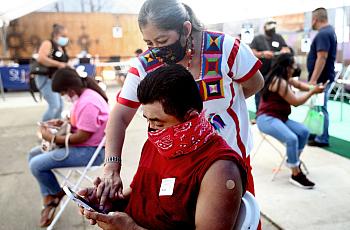  A mobile clinic vaccinates Central American Indigenous residents in Los Angeles in April.