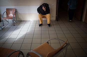 Man seated in clinic waiting room